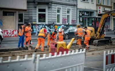 group of men in orange suit standing near building during daytime